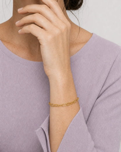 Vertical wrist wearing view of Vela gold paperclip bracelet