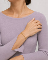 Overlapped-hands detail of Vela gold paperclip bracelet
