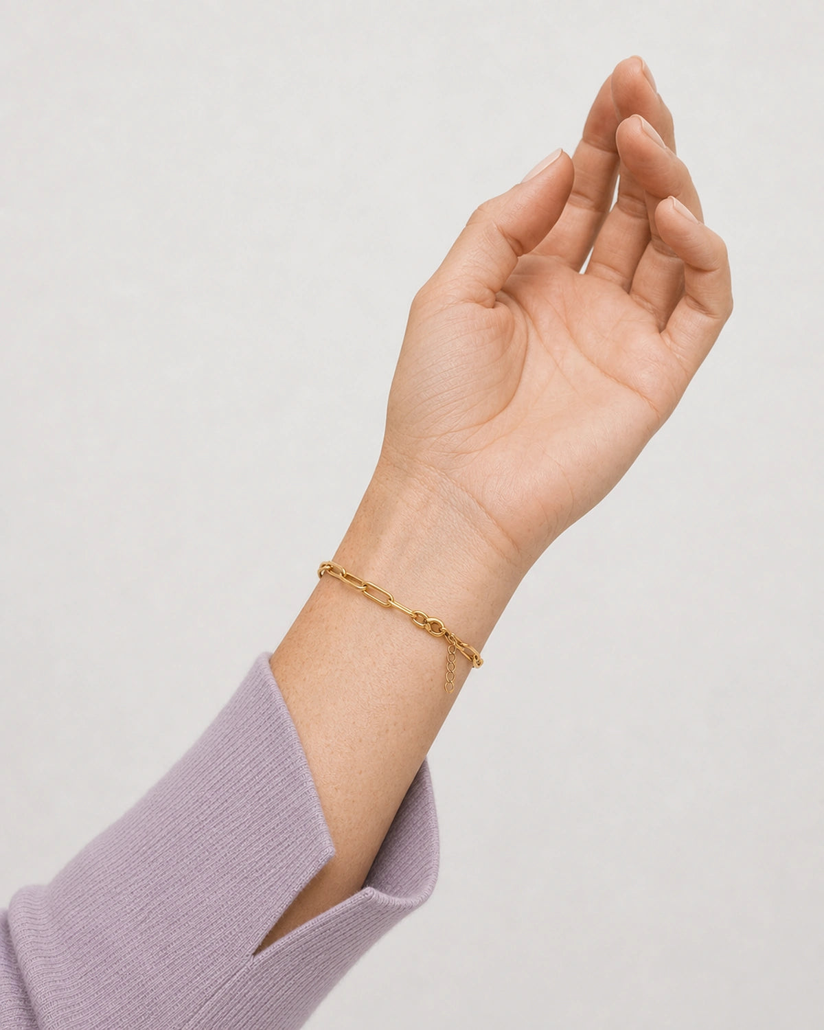 Palm-up wrist detail of Vela gold paperclip bracelet