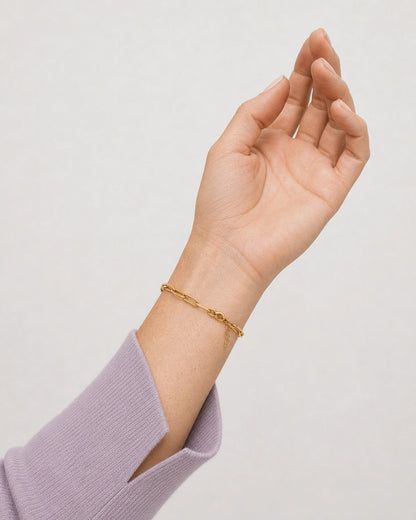 Palm-up wrist detail of Vela gold paperclip bracelet