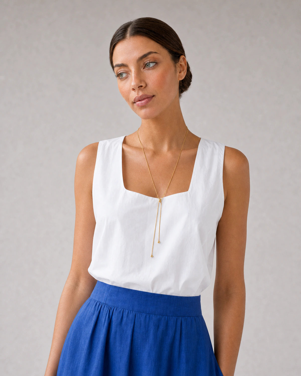 Alternate Riviera portrait featuring the Vela gold lariat necklace