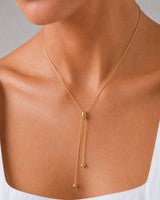 Extreme macro of the Vela slider and two bead-tipped chain tails