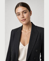British model wearing the Vienne crystal T-bar necklace with a charcoal blazer
