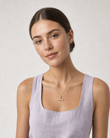 Model in lilac summer linen wearing the Vienne gold crystal T-bar necklace
