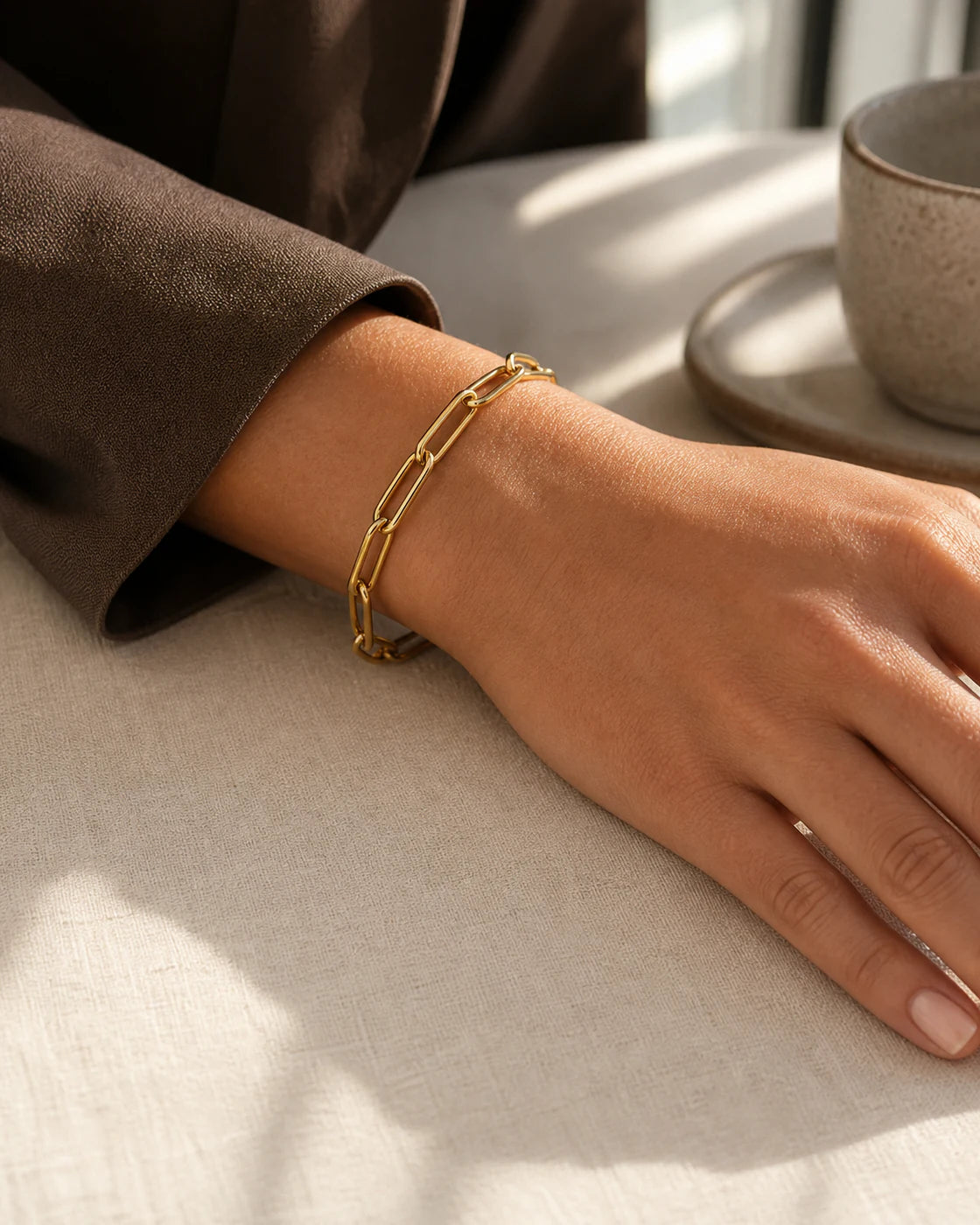 Hand wearing a Valoraie gold bracelet