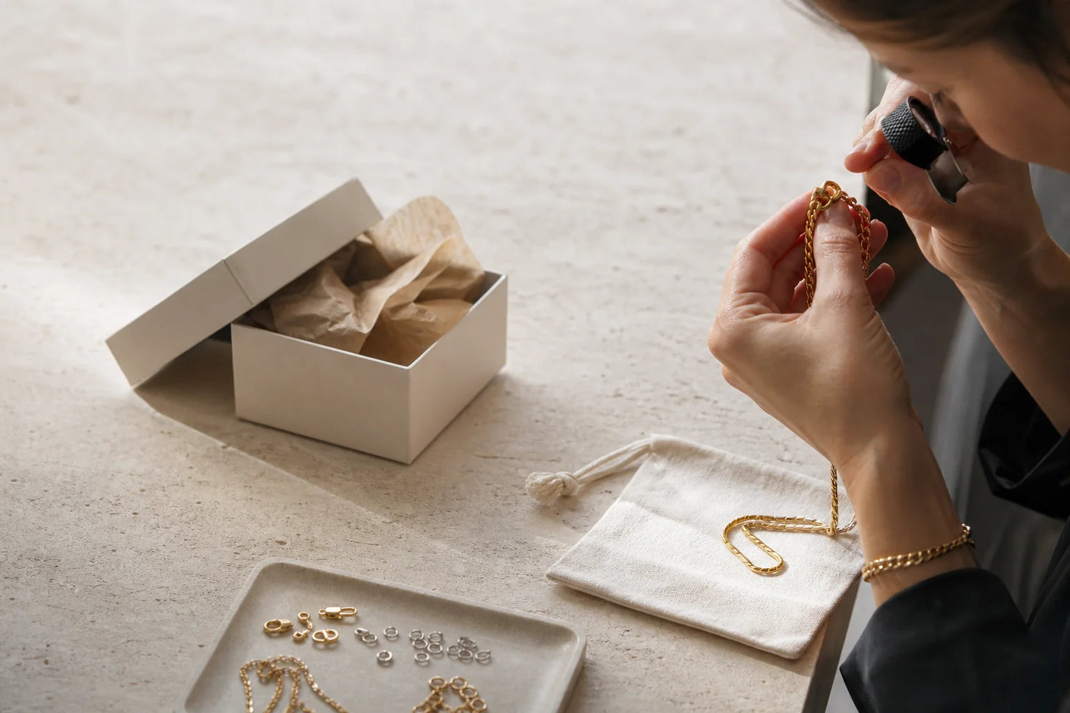 Valoraie jewellery being inspected beside considered paper packaging